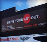 NZ Art Show billboard on the side of the wall